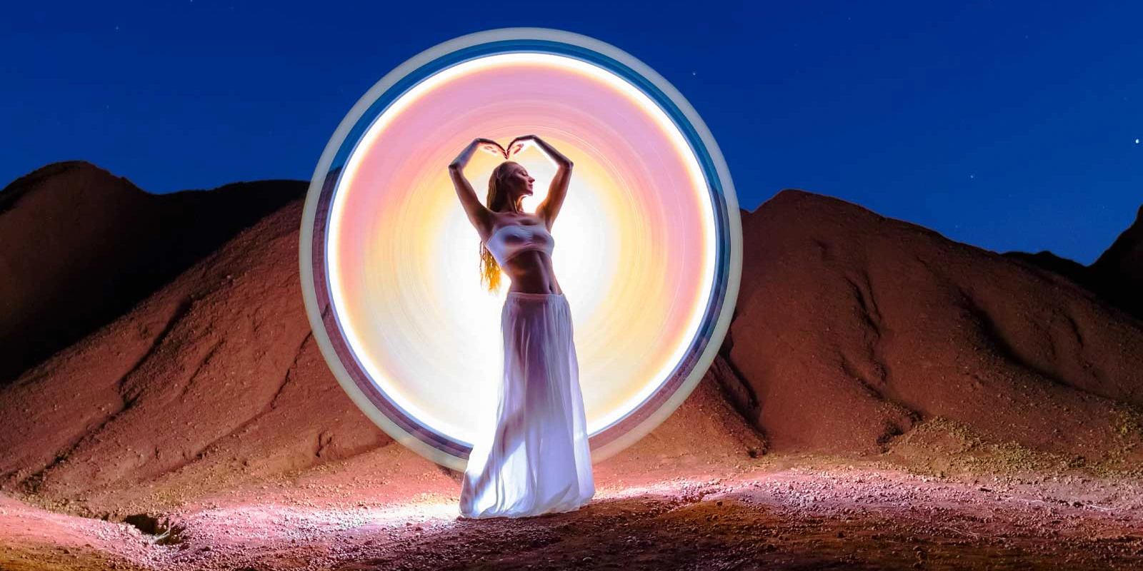 Andrea Riezzo creating light-painting photography on a beach